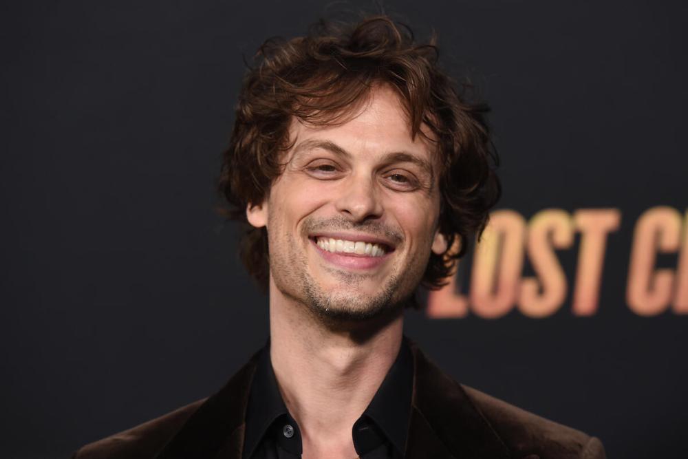 Matthew Gray Gubler standing on set, smiling and interacting with crew