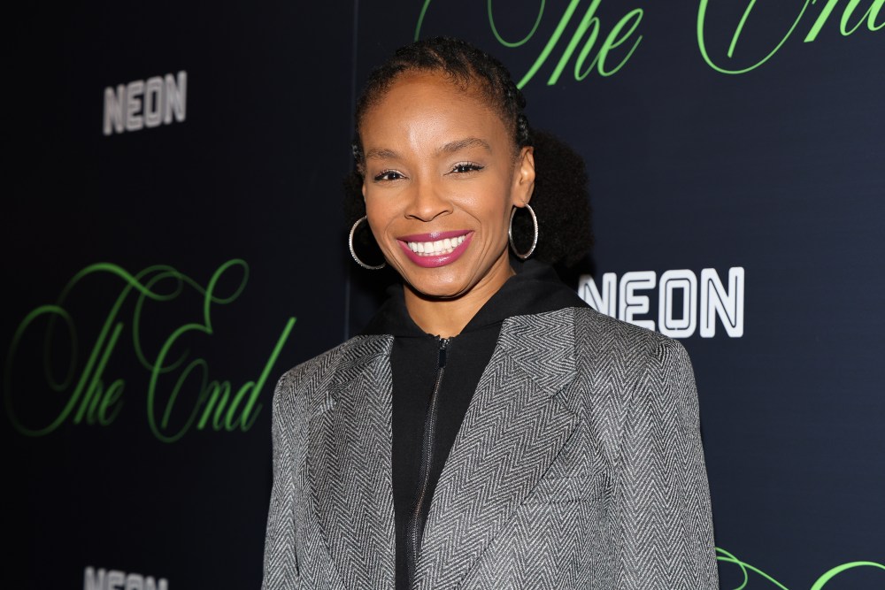Amber Ruffin smiling during an interview, exemplifying her comedic presence