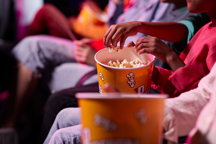 Couple enjoying a film in a movie theater, surrounded by cinema ambiance