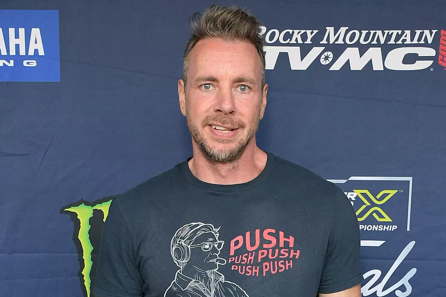 Dax Shepard smiling at a live event