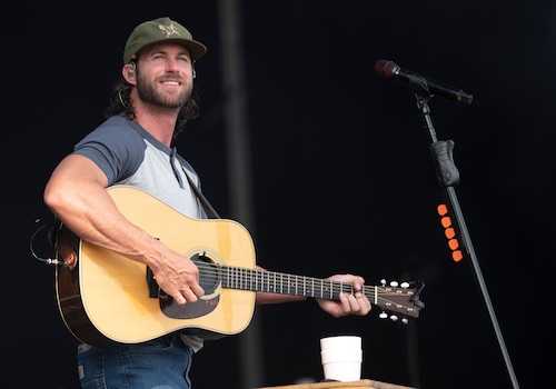 Riley Green performing on stage in 2025