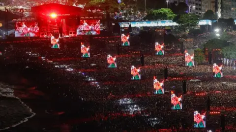 Panoramic view of Copacabana Beach filled with concertgoers
