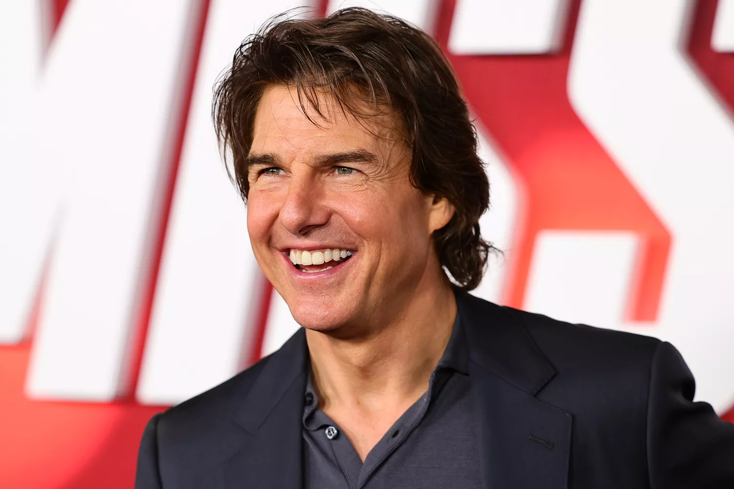 Tom Cruise as Ethan Hunt performing a daring stunt in Mission Impossible