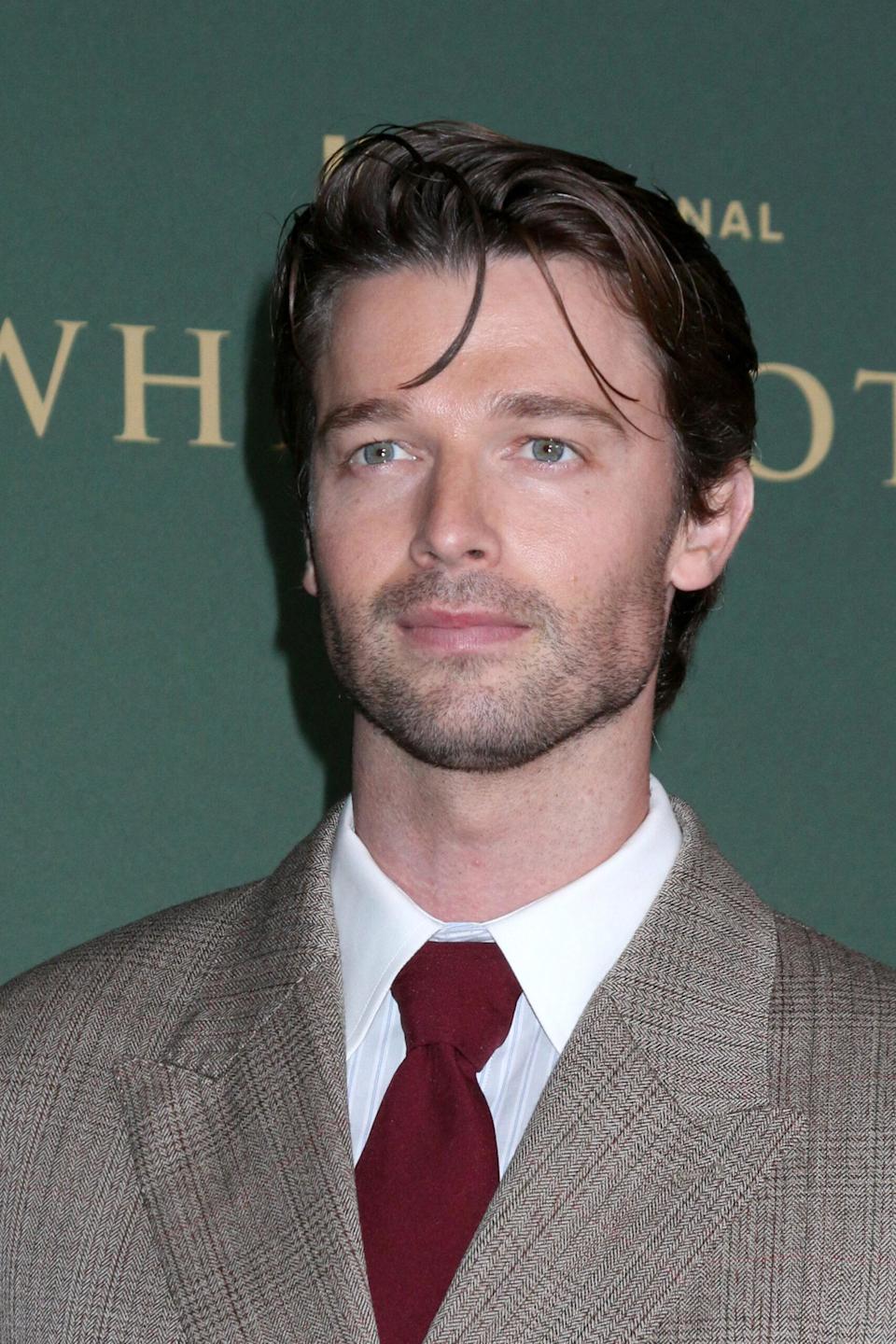 Patrick Schwarzenegger smiling at an event
