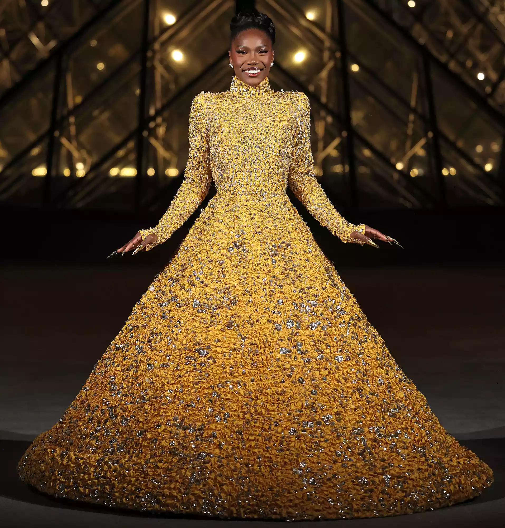 Doechii poses on the Met Gala red carpet in a Louis Vuitton suit, capturing her debut moment.