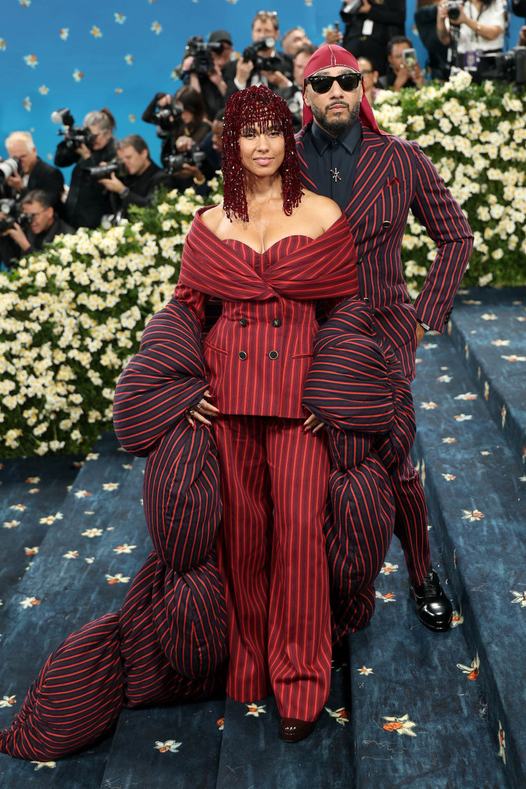 Alicia Keys wears a red pinstripe suit and beaded headpiece at the 2025 Met Gala