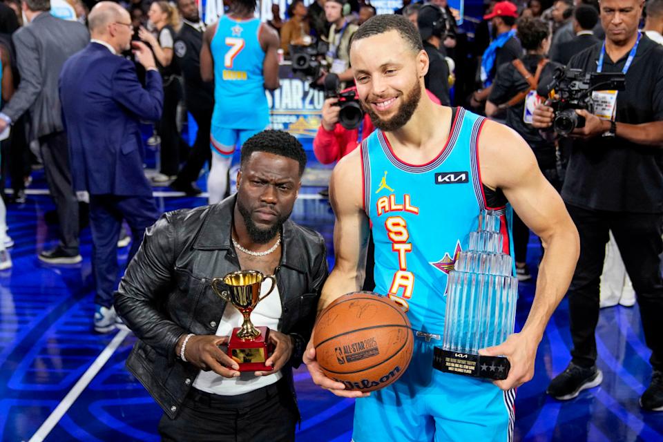 Kevin Hart posing at an event, spotlight on his vibrant energy.