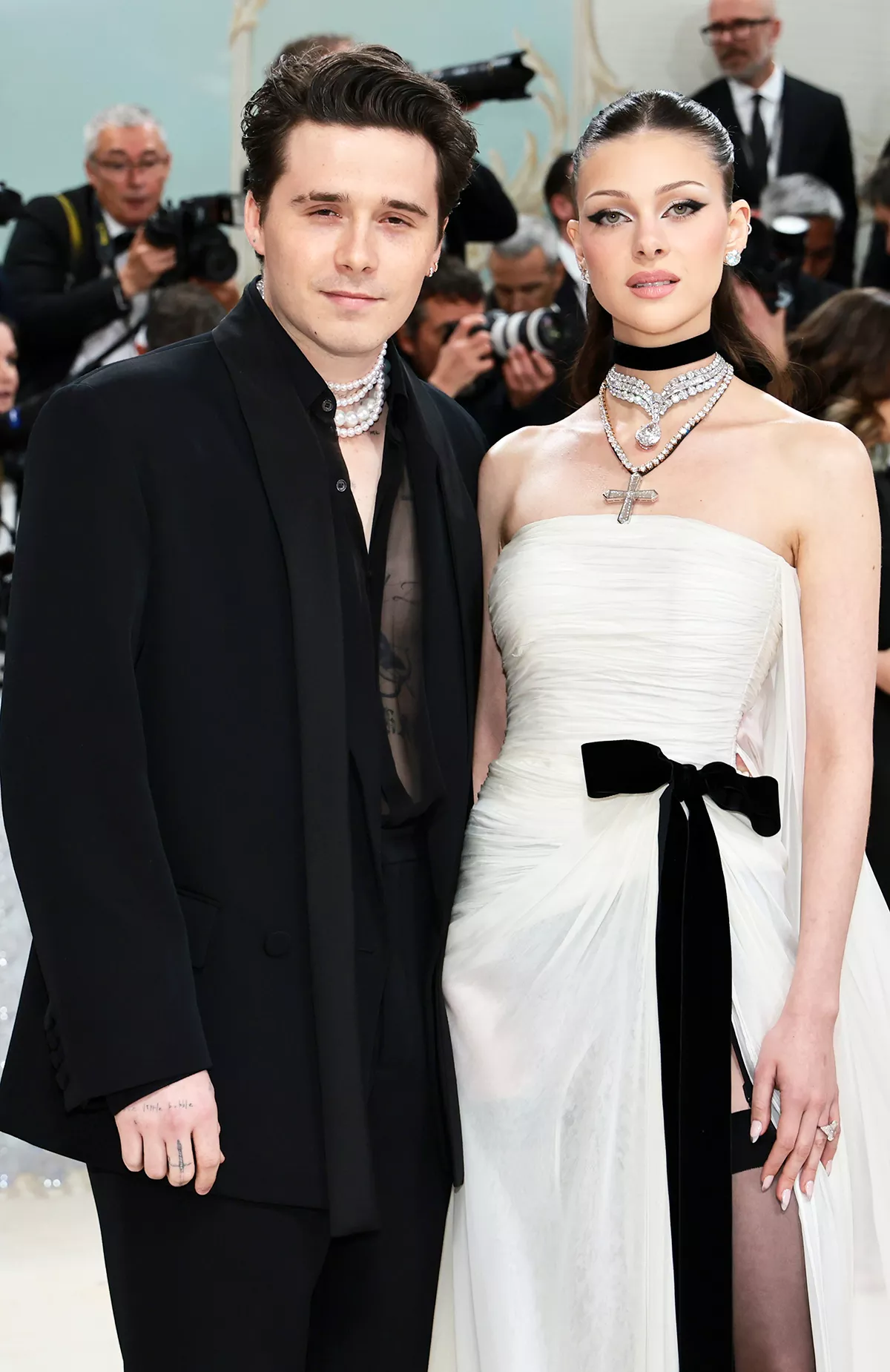 Nicola Peltz with Brooklyn Beckham at a public event, focus on family dynamics