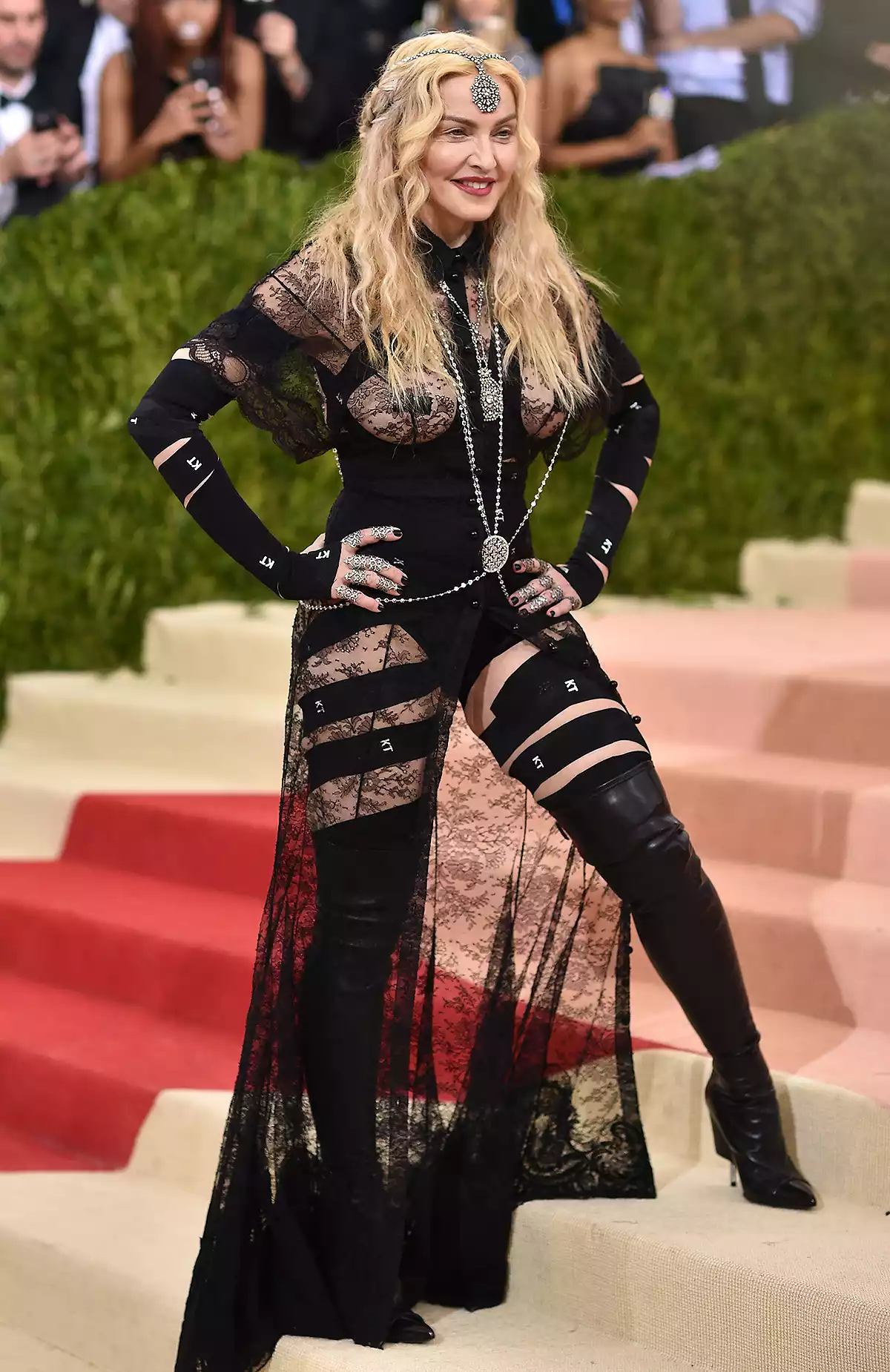Madonna at the 2025 Met Gala in a sleek white suit with a cigar