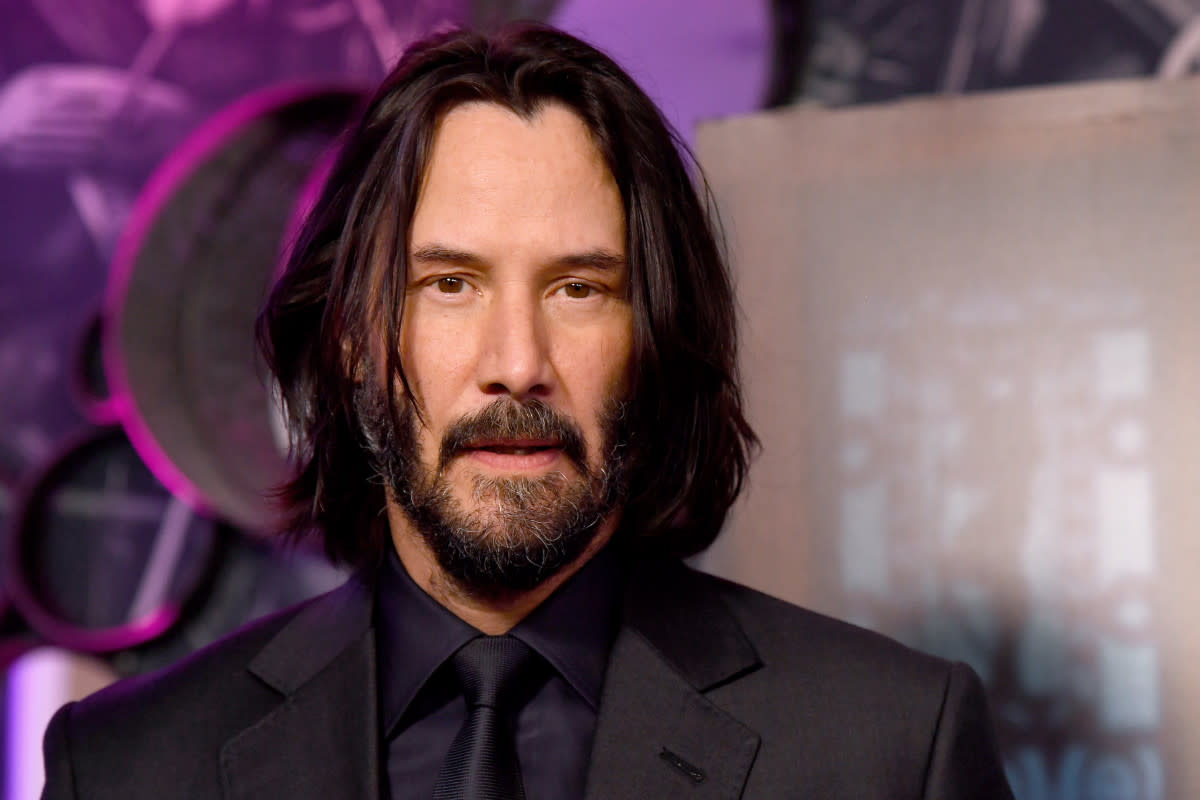 Keanu Reeves as John Wick walking in a dramatic action scene