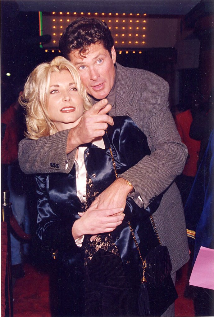David Hasselhoff with wife at the airport, seen in a wheelchair.