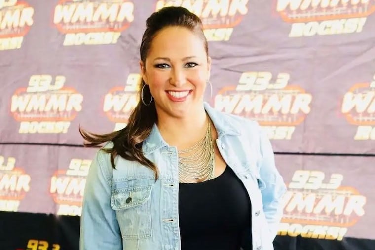 Kathy Romano behind the microphone at WMMR radio studio