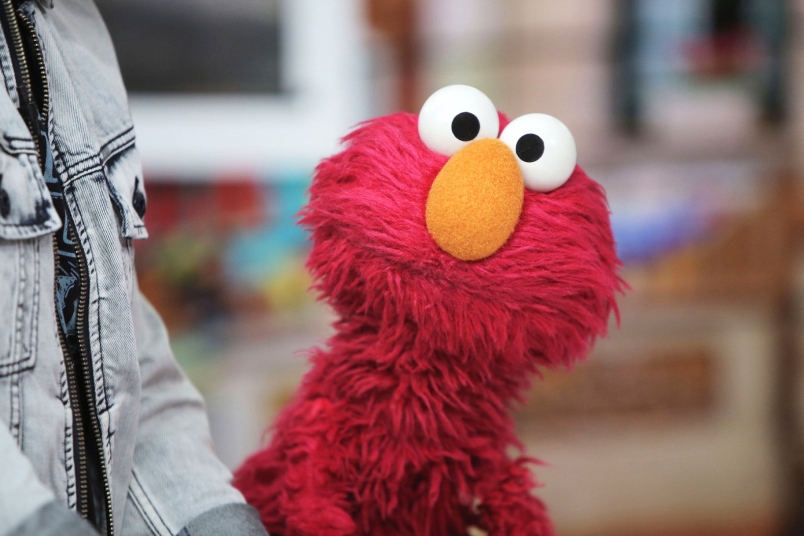 Elmo smiling on Sesame Street, central to the viral layoff post