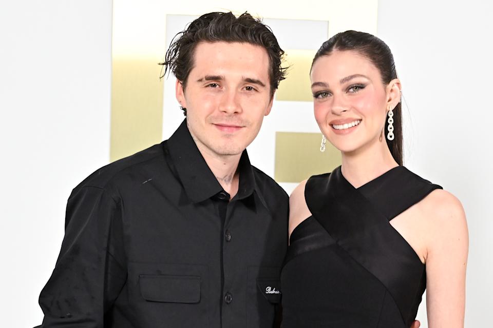 Nicola Peltz posing with the Beckham family during happier times