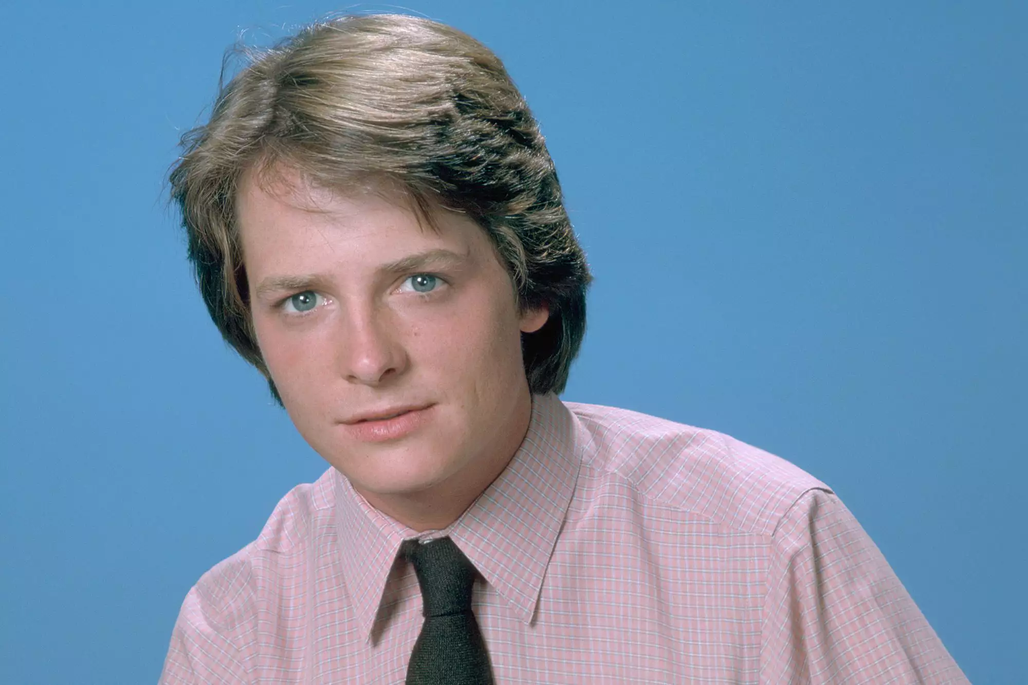 Michael J. Fox poses at an event, furthering his advocacy and Hollywood legacy