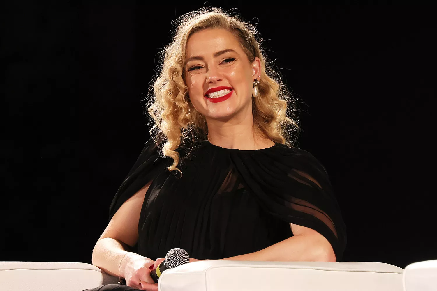 Amber Heard holding her newborn twins, celebrating her family milestone
