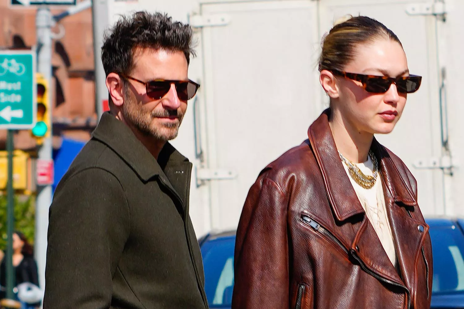Gigi Hadid smiling with Bradley Cooper at her birthday celebration, highlighting Hadid's happiness and family life
