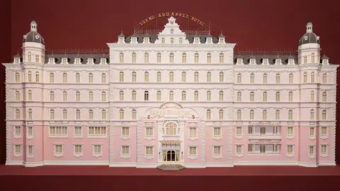 Grand Budapest Hotel model on display at the Design Museum, representing Wes Anderson’s signature aesthetic.