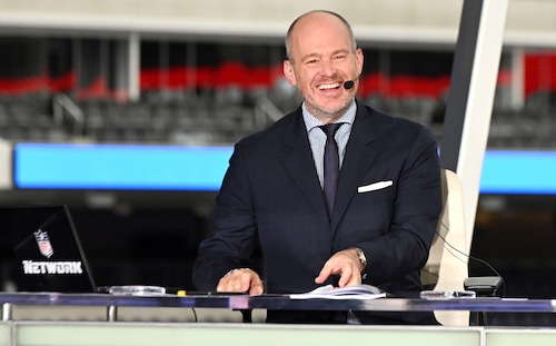 Rich Eisen smiling at a media event, marking his return to ESPN
