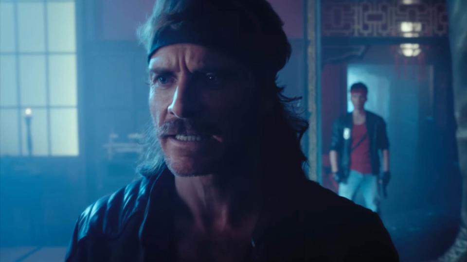 Kung Fury 2 cast pose for an action scene, including Michael Fassbender and Arnold Schwarzenegger