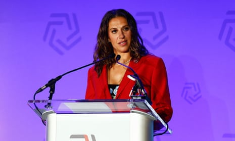 Carli Lloyd holding a trophy during her career, symbolizing her achievements as an inspirational player and leader.