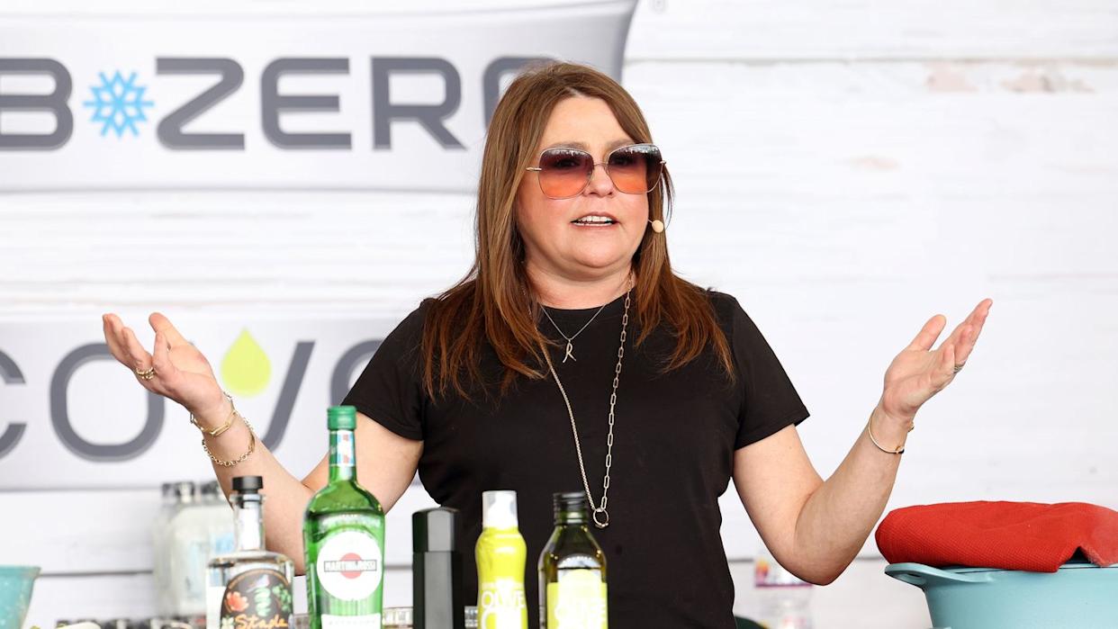 Rachael Ray smiling in her kitchen, representing Rachael Ray health and wellness