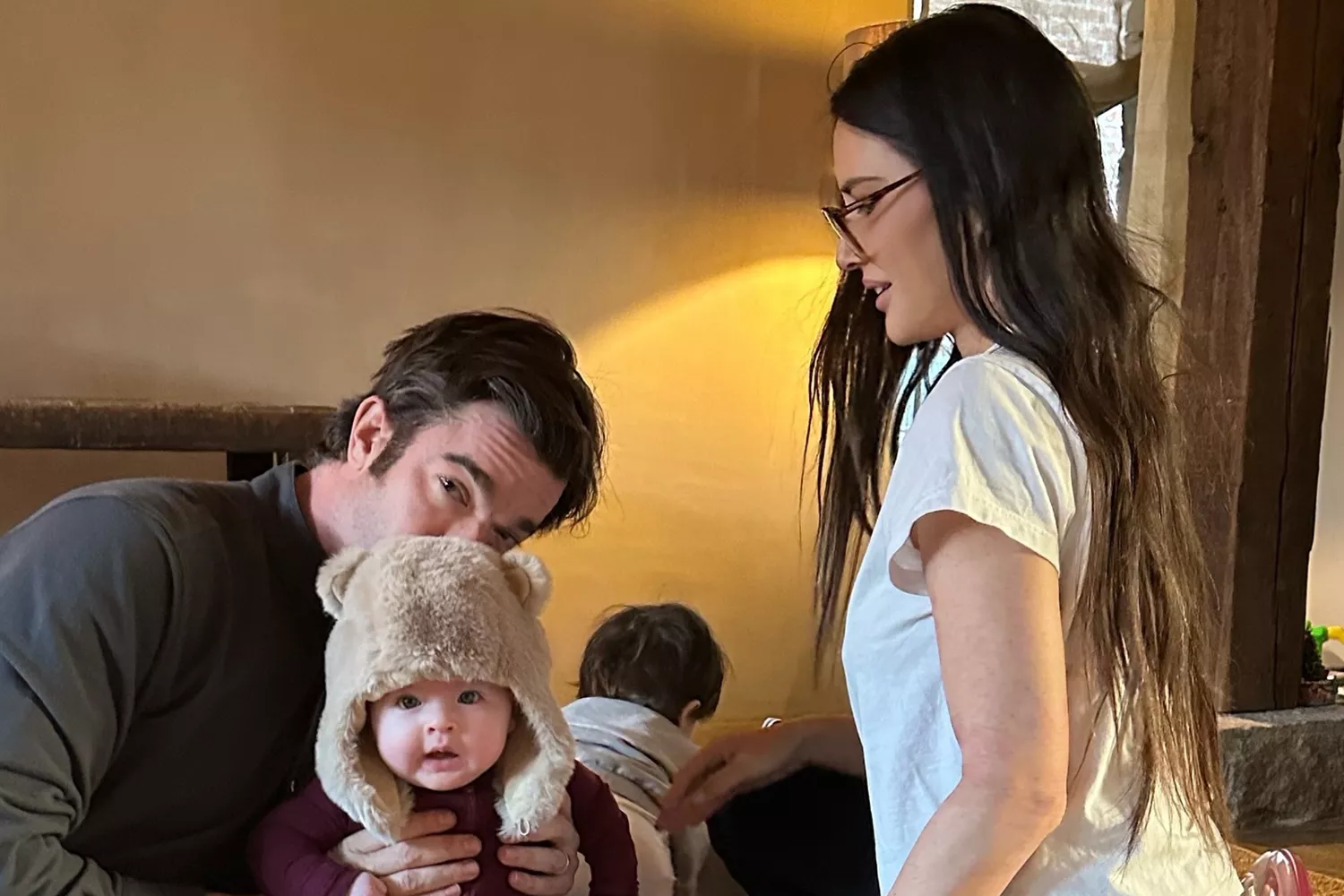 Olivia Munn smiling with her family, highlighting her motherhood journey