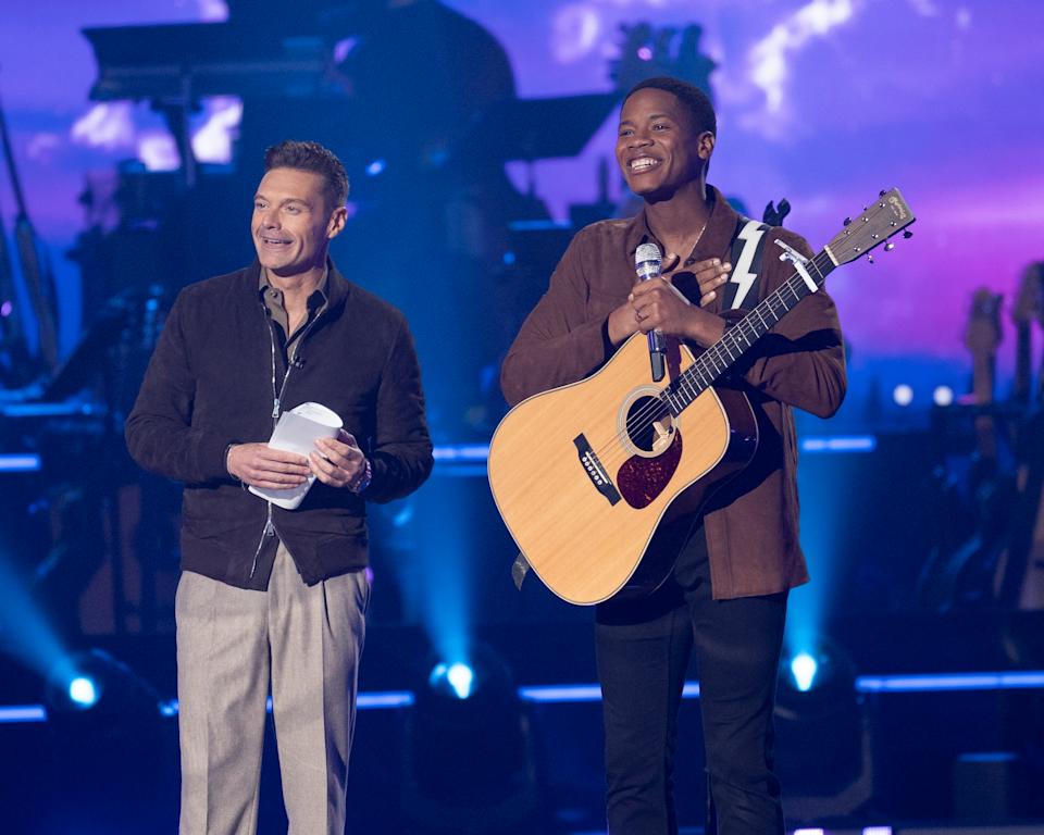 Ryan Seacrest smiling on stage