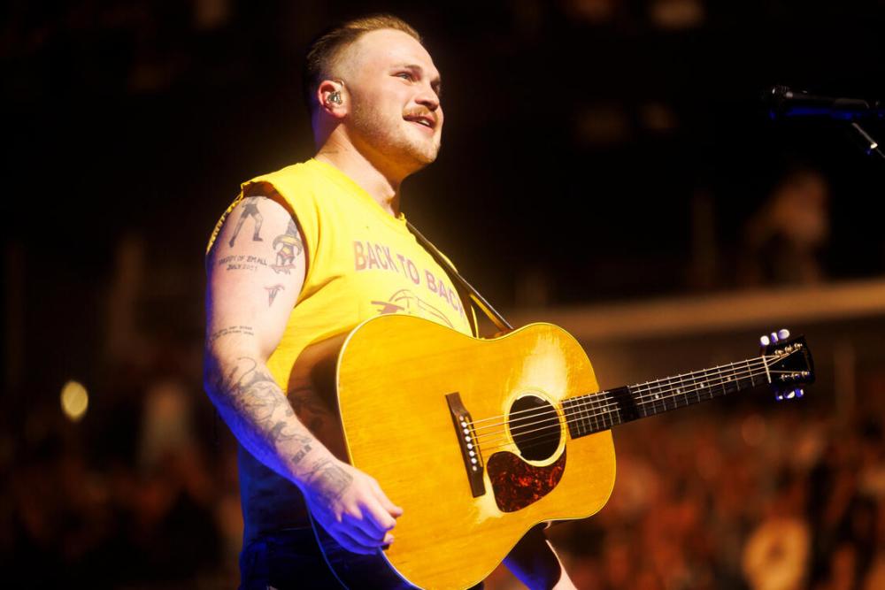 Zach Bryan performing live on stage