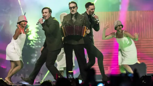 Eurovision contestants celebrating on stage at the 2025 event in Basel
