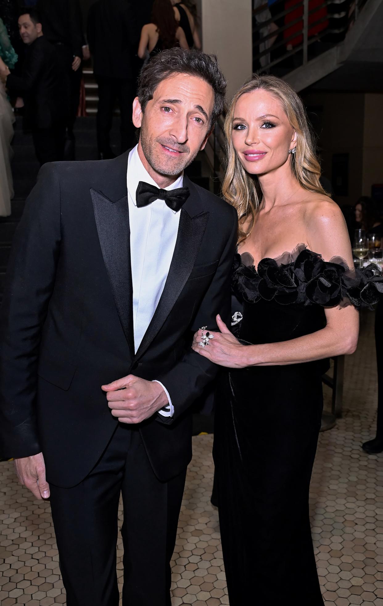 Adrien Brody at a recent event, smiling on the red carpet
