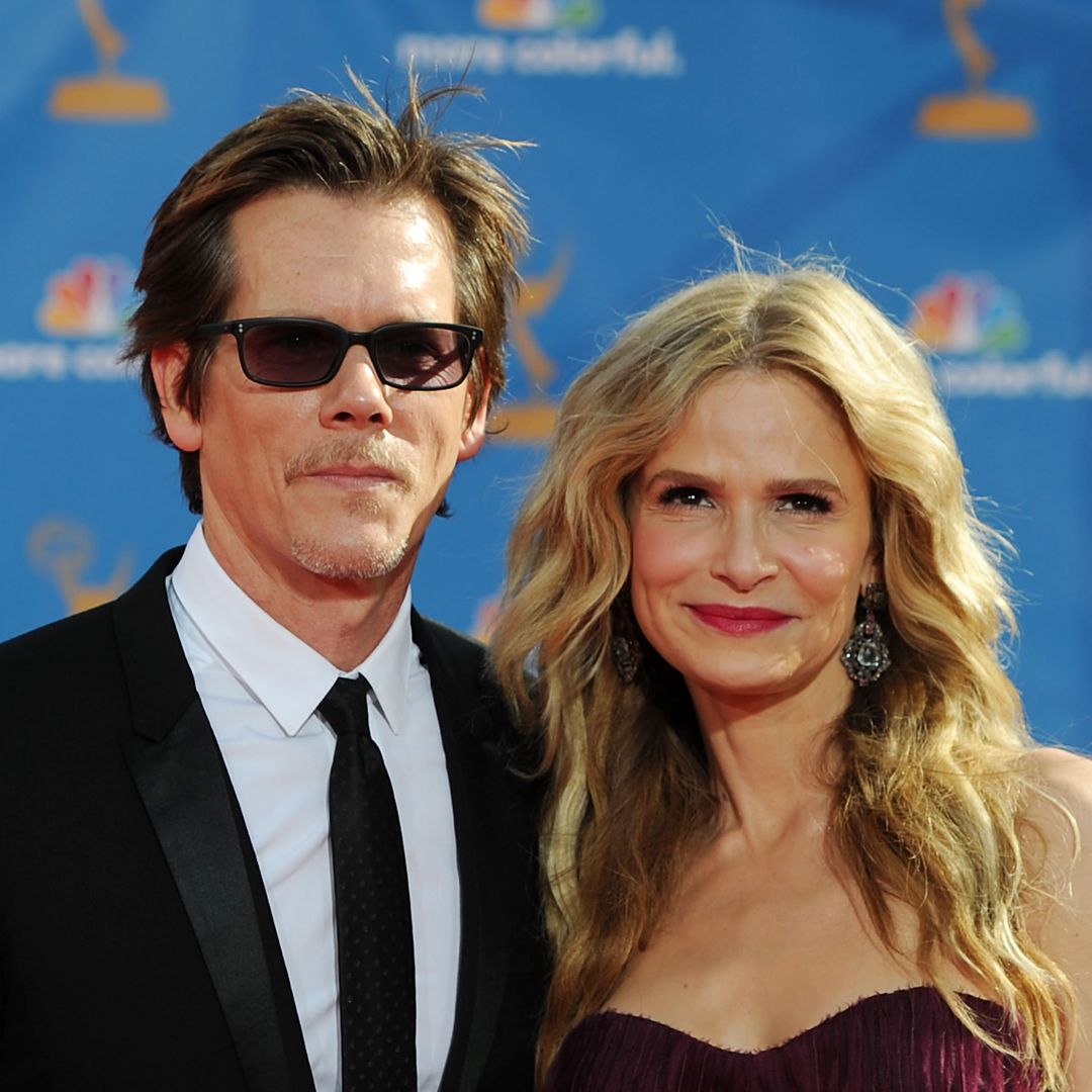 Kevin Bacon smiling at an event, showcasing his enduring charm.