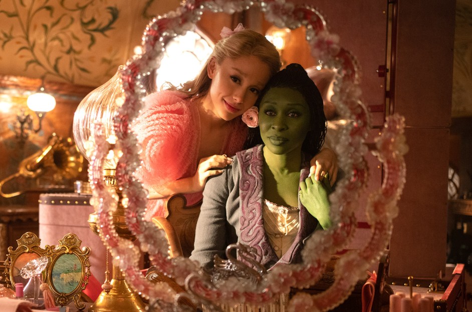 Cynthia Erivo and Ariana Grande in Wicked movie poster, magical landscape