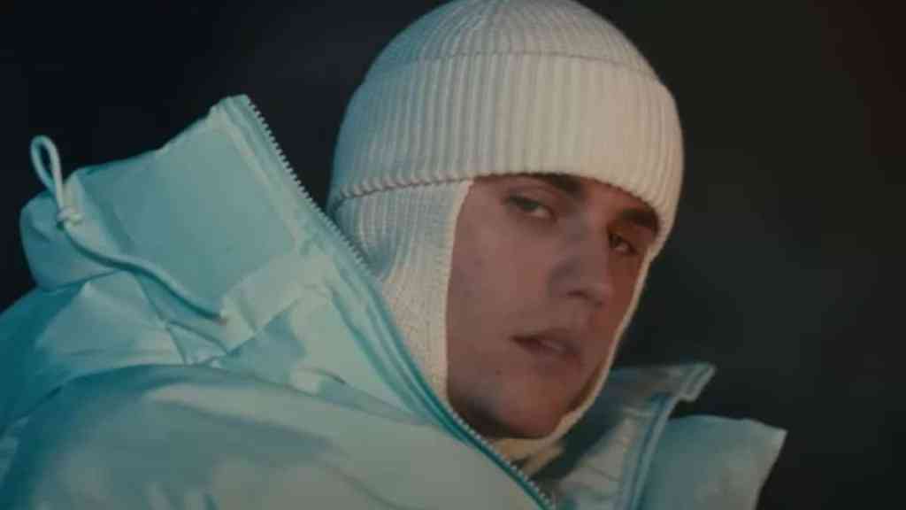 Justin Bieber performing on stage, symbolizing his career success and financial journey
