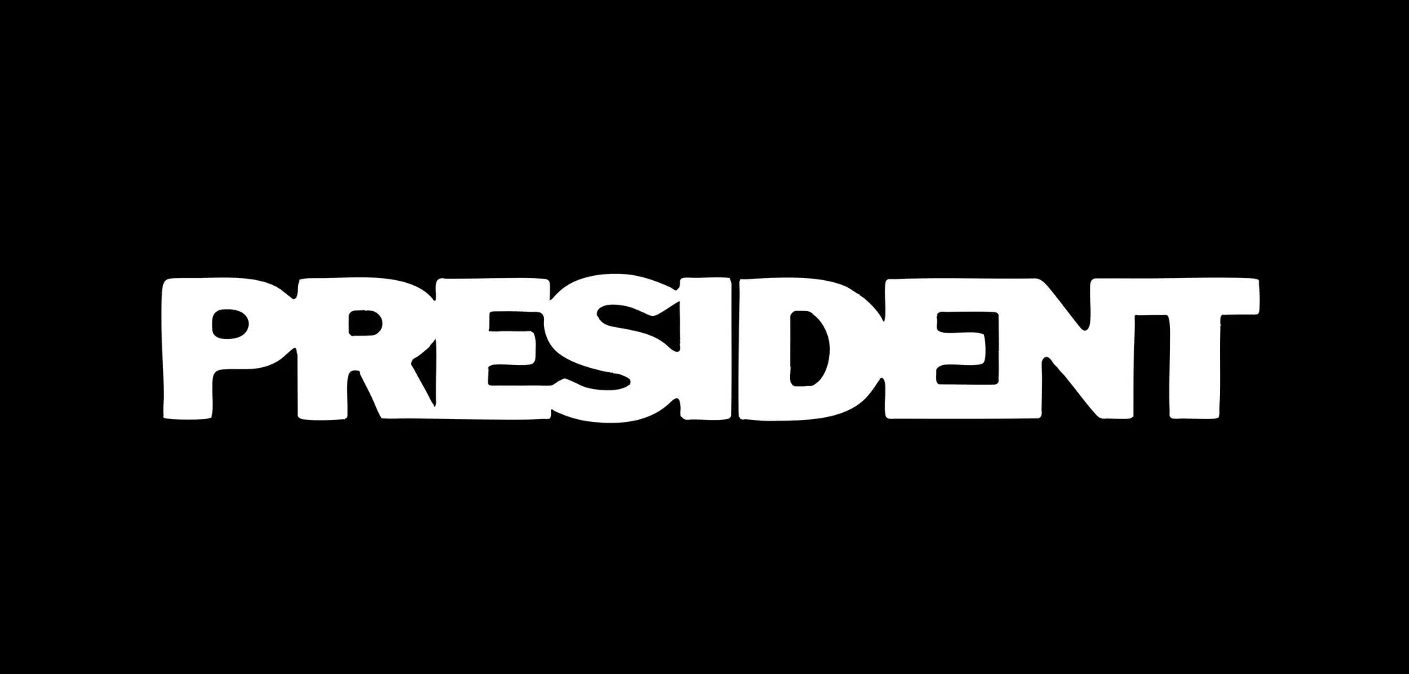 Masked member of the president band, shadowed against red light at Download Festival