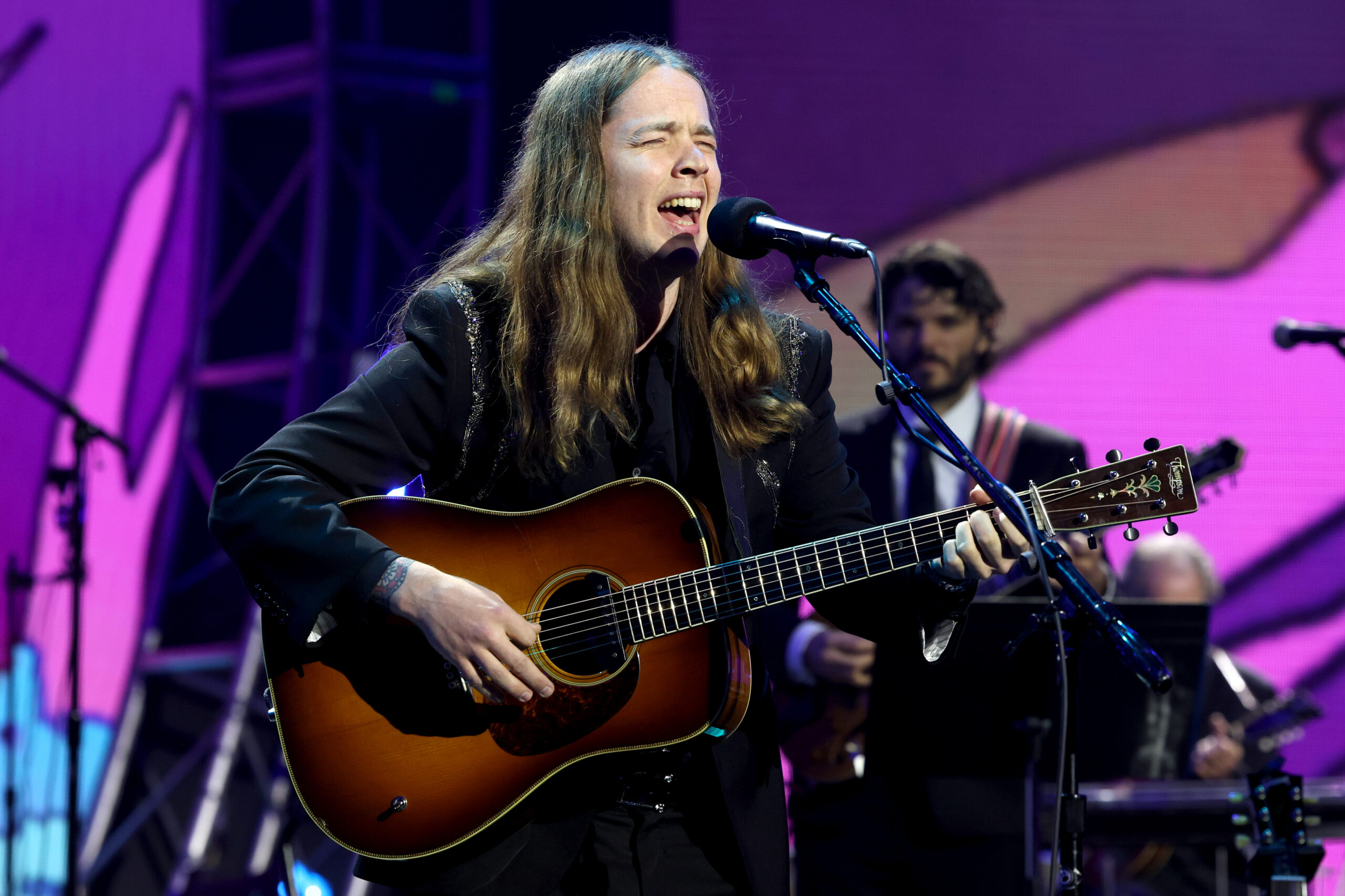 Billy Strings live performance with vibrant stage lights