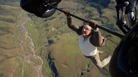 Tom Cruise in Mission Impossible 7 performing a daring stunt