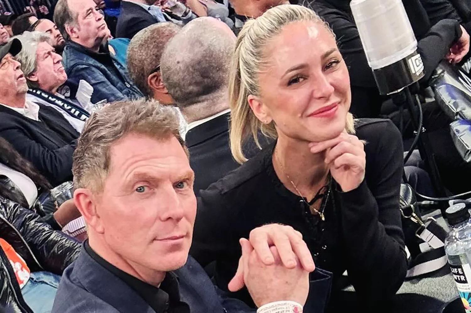 Bobby Flay smiling at an event, showcasing his charismatic presence as a celebrity chef