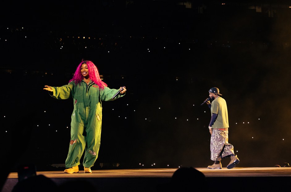 SZA performing live on stage, showcasing her unique style and connection with the crowd.