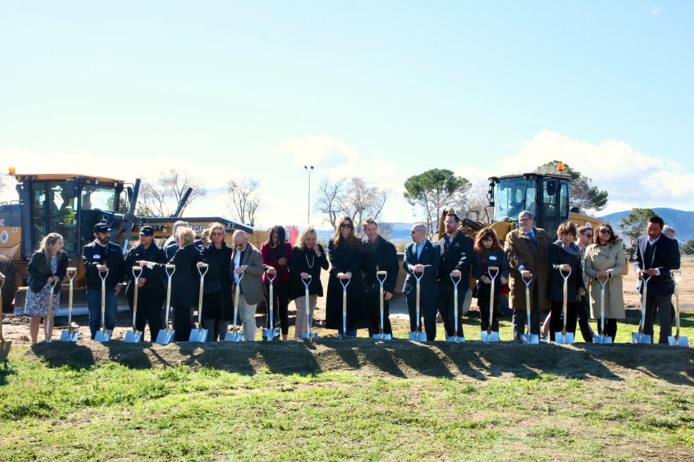 Christian Bale speaking at a foster care center groundbreaking, demonstrating his real-life heroism