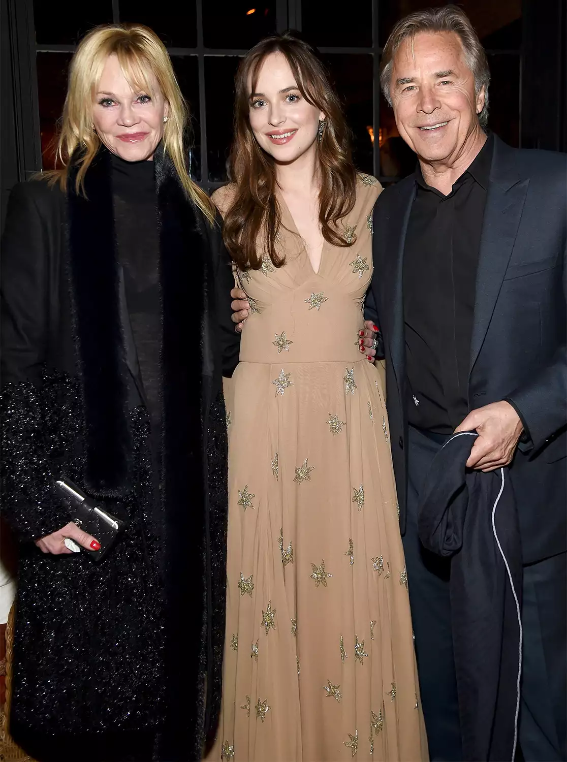 Don Johnson and his daughter Dakota Johnson smiling together at a public event