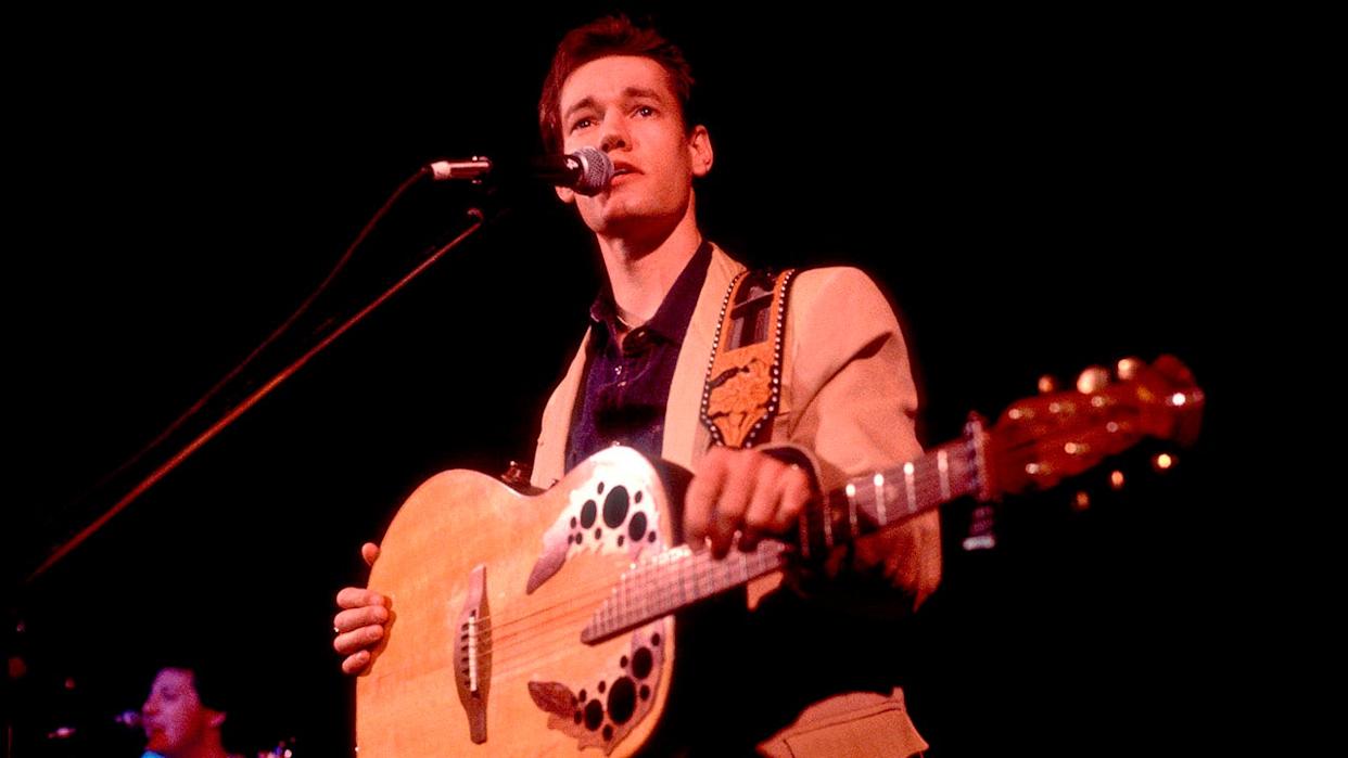 Randy Travis performing live on stage, marking his inspiring comeback