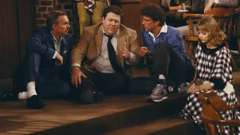 George Wendt as Norm Peterson in Cheers