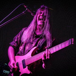 Tim Pierce performing live on stage, showcasing his legendary guitar skills
