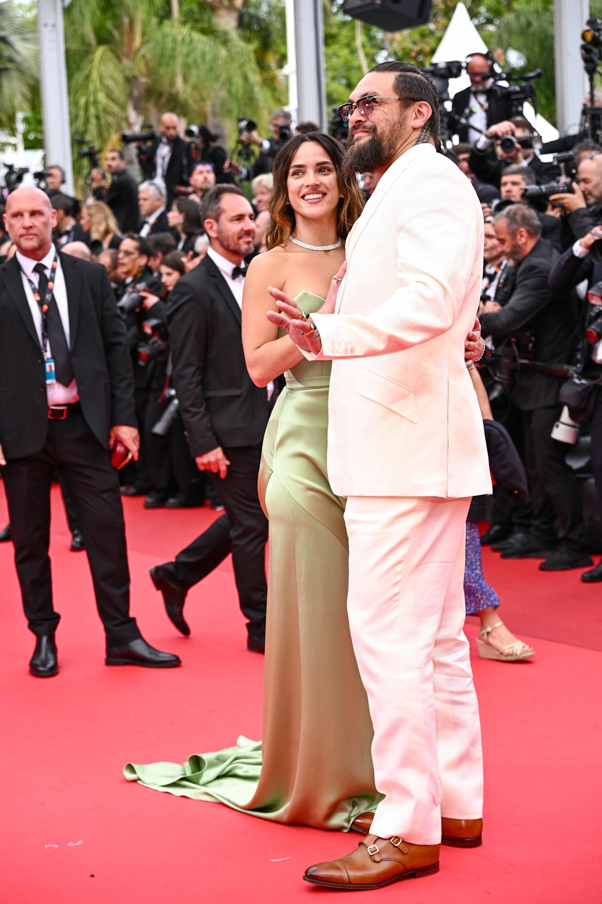 Adria Arjona and Jason Momoa on the Cannes red carpet, looking elegant and happy together.