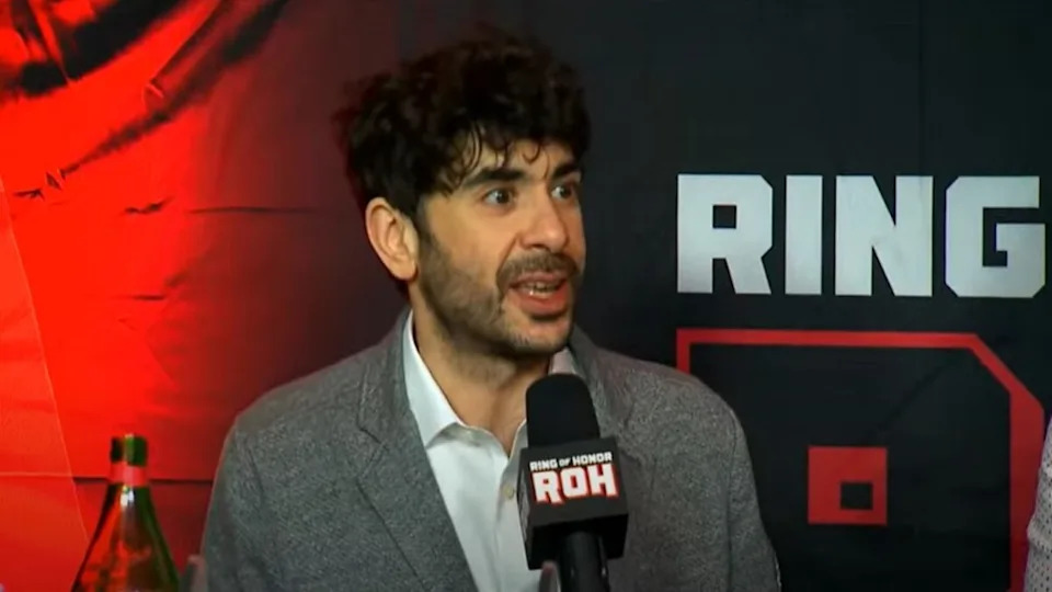Tony Khan with AEW talent in a dynamic moment